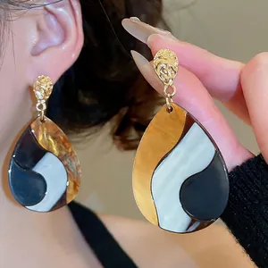 Ethnic vintage teardrop earrings with golden hammered metal and tricolor resin inlay