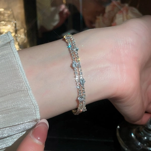 Detail of double-layer 18k gold plated bracelet with sparkling round zircons