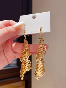 Detailed close-up of 18k gold plated tassel earrings with sparkling mesh sequins and diamonds