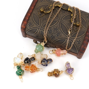 Handmade gold wire-wrapped mushroom stone pendants in various natural crystal colors