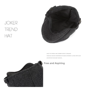 Detail view of charcoal wool newsboy cap featuring sweatband and adjustable metal buckle