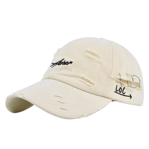 Detail of beige distressed baseball cap featuring metal rings and Asher embroidery