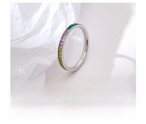 Detailed macro view of colorful zircon crystals set in a silver steel band ring