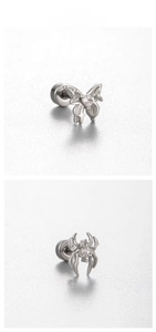 Detailed close-up of butterfly and spider stud earrings with zircon inlays