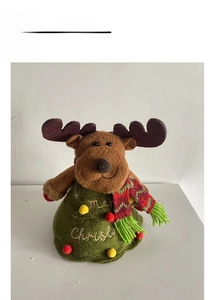 Close-up of reindeer plush Christmas decoration with Merry Christmas embroidery and scarf