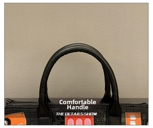 Close-up of dual round handles on a black crocodile pattern bag with embroidery detail