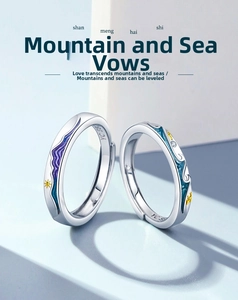 Macro detail of S925 silver couple rings featuring purple mountain and blue wave designs