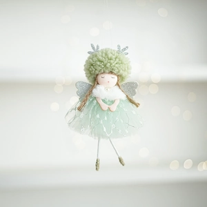 Close-up of mint green plush Christmas angel with sparkling wings and knit details