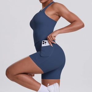 Detail of dark blue yoga set shorts with side pocket showing phone storage function