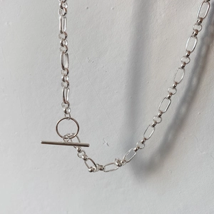 Detail of a 925 silver OT toggle clasp necklace with alternating round and oval links