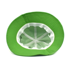 Detail view of the green cotton bucket hat showing interior sweatband and embroidery