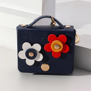 Navy blue faux leather mini purse keychain with 3D white and red floral accents