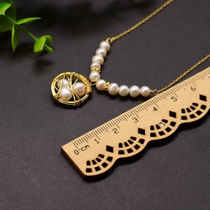 Golden handmade bird nest pendant necklace with natural freshwater pearls and thin chain