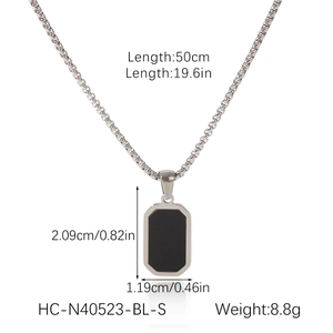 Silver chain necklace with black rectangular pendant and size measurements in cm and inches