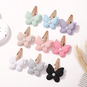 Handmade butterfly hair clips with shimmering fabric and pearl centers for girls