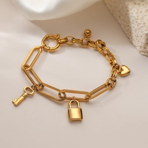 18K gold plated chain bracelet featuring heart lock and key pendants on silk texture