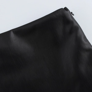 Detailed macro view of the premium black PU leather texture with high-gloss finish