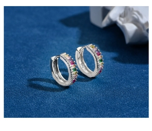 Detailed macro view of 925 sterling silver hoop earring with multi-color zircon stones