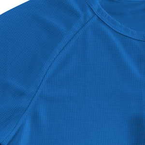 Detailed macro view of royal blue waffle knit texture and stitching on men's henley shirt