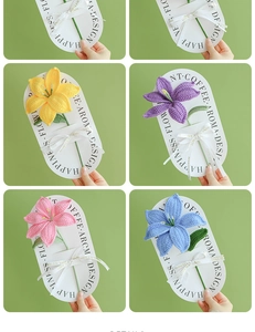 Detail showing four colors of handmade crochet lily bouquets on elegant white cards