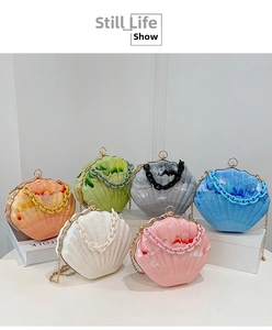 Close-up of marble texture shell bags in multiple colors with gold chain straps