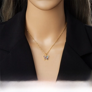 Detailed view of a gold-plated butterfly pendant with purple gradient resin on a model