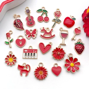 Detailed flat lay of red enamel alloy charms in various fruit and flower shapes