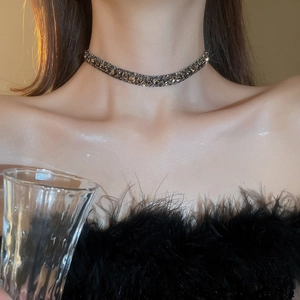 Close-up of a square zircon necklace worn by a model showcasing high-end style