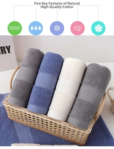Close-up of four thick cotton towels in a bamboo basket showing honeycomb texture