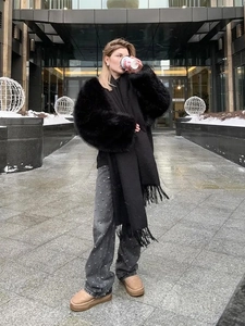 Chic faux fur jacket paired with fringe scarf, studded jeans and winter platform boots