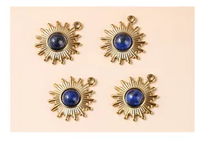 Detail of four golden sunburst pendants with natural blue lapis lazuli stone centers