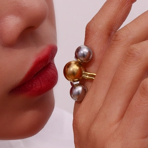 Detailed view of women's adjustable ring with 18K gold and silver tri-ball design