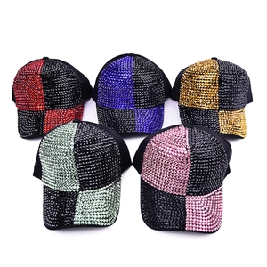 Close-up of five rhinestone baseball caps in various colors with a checkerboard diamond pattern
