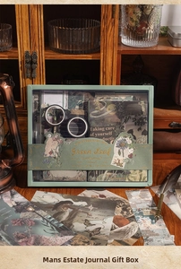 Detailed close-up of a vintage stationery gift set with notebook, tapes, and stickers