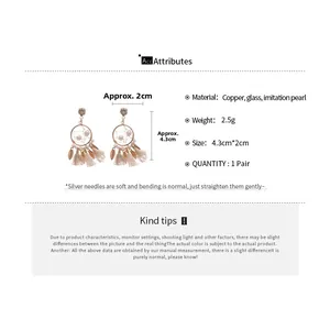 Detailed view of dreamcatcher earrings with pearl tassels and glass beads on silver needles