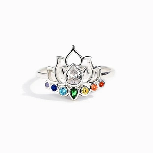 Lotus flower ring with colorful cubic zirconia and pear-shaped stone on white background