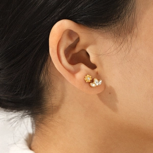Three-piece stainless steel gold stud earrings with cubic zirconia flower and leaf designs