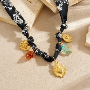 Vintage beaded necklace with heart coin, amber beads and fabric strap on stone base