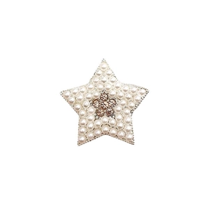 Star-shaped alloy accessory featuring white pearls and a gold rhinestone flower center