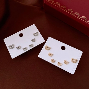 Close-up of gold and silver bear earrings with cubic zirconia on velvet background