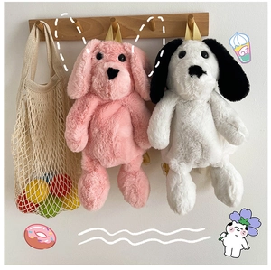 Detail of plush dog backpacks in pink and white with soft fuzzy texture and yellow straps