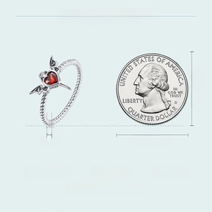 Size comparison of Gothic bat wing silver ring with red heart gemstone and US quarter