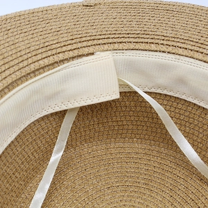 Detail of inner straw weaving with adjustable ribbons and white sweatband on wide brim hat