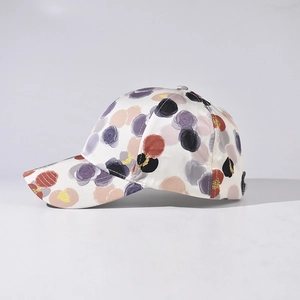 Polka dot baseball cap with colorful abstract pattern shown in a 45-degree side view