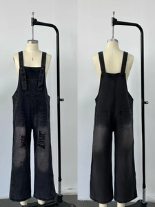 Detailed front and back view of vintage black washed distressed denim overalls with ripped details
