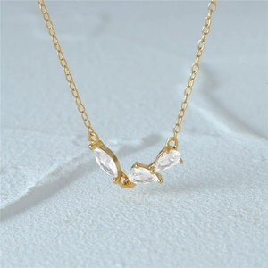 Close-up of a 925 silver gold-plated cluster pendant with marquise and pear cut zircons