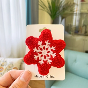 Detailed view of red snowflake embroidery patch with high-quality 3D knit texture