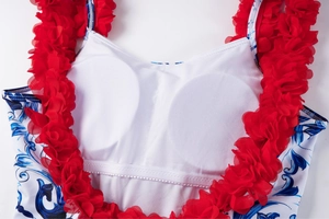 Detail of swimsuit interior featuring built-in round bra pads and contrast mesh ruffle straps