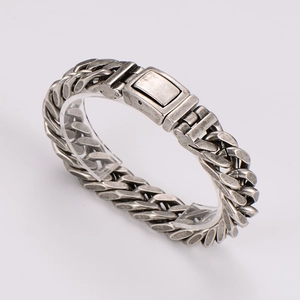 Macro detail of vintage cuban chain bracelet with square metal buckle clasp