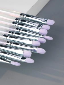 Detail of soft purple synthetic fiber bristles and silver metal ferrules on makeup brushes